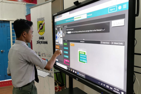 Student uses interactive smart whiteboard for classwork.